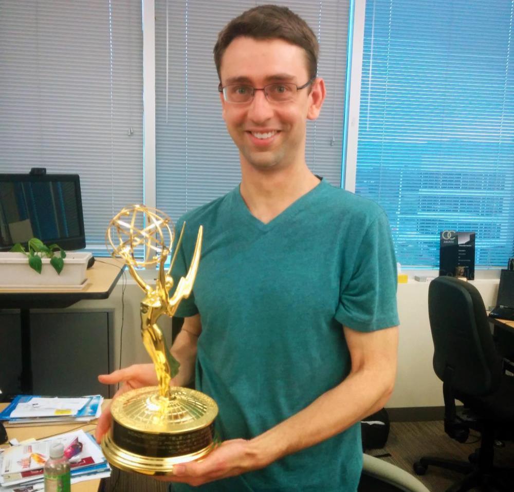 Simon Newton holding emmy statue in hands